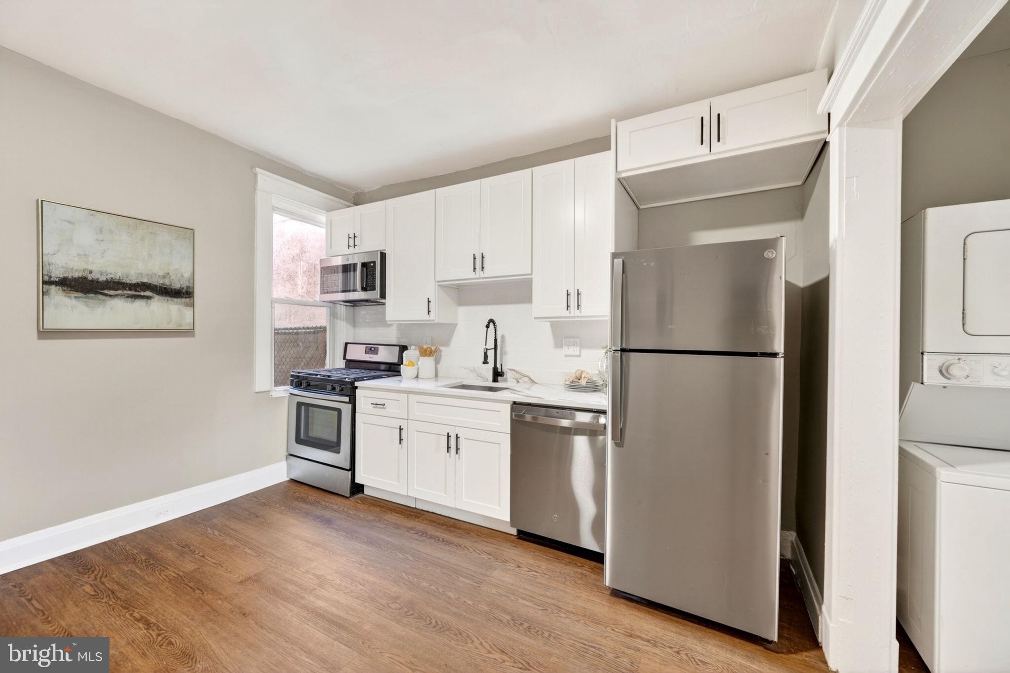 1358 Homestead Street Baltimore, MD 21218 - Photo 18 of 35 a kitchen with stainless steel appliances granite countertop a refrigerator sink and microwave