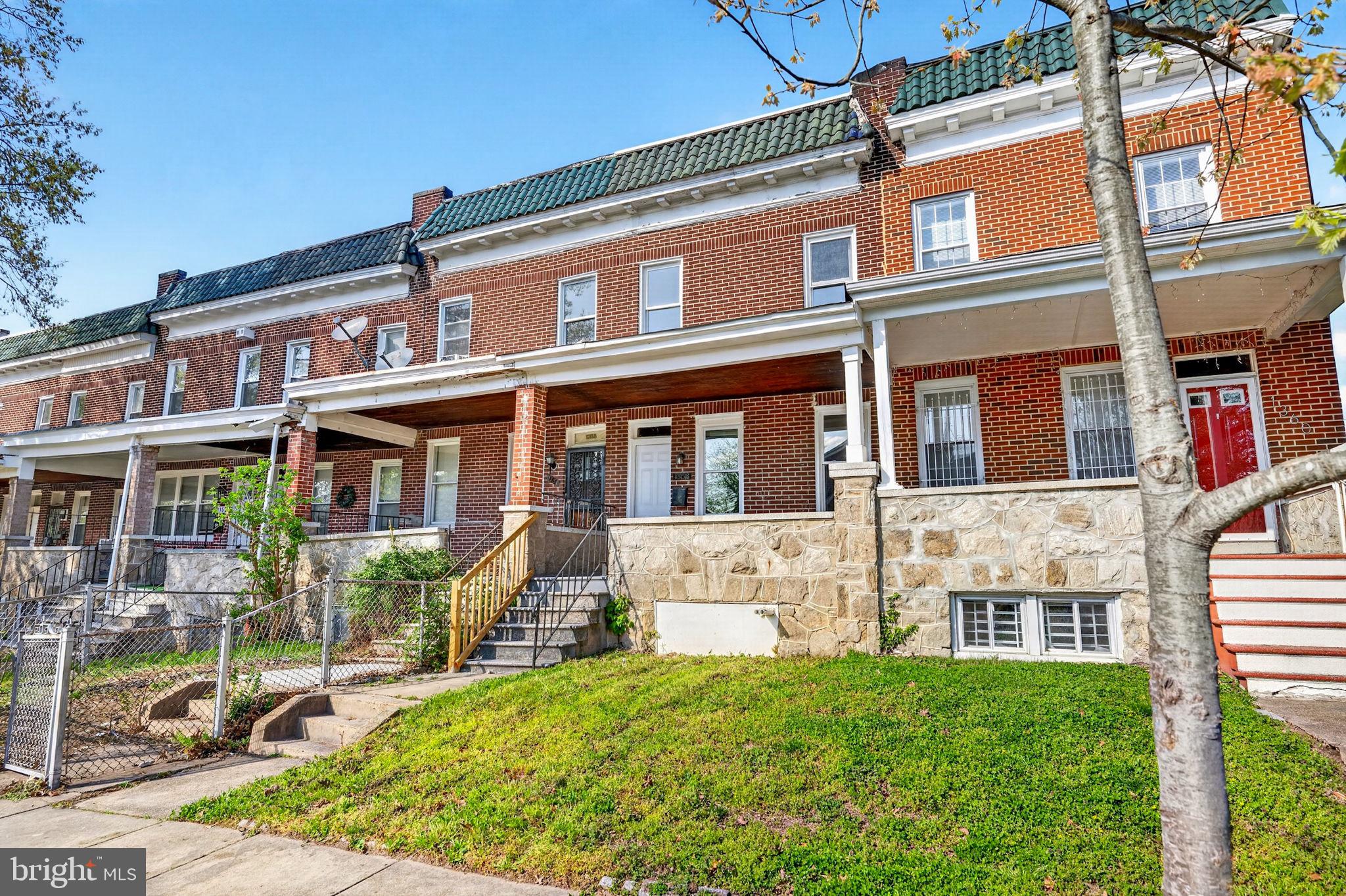 1358 Homestead Street Baltimore, MD 21218 - Photo 2 of 35 front view of a brick house with a yard