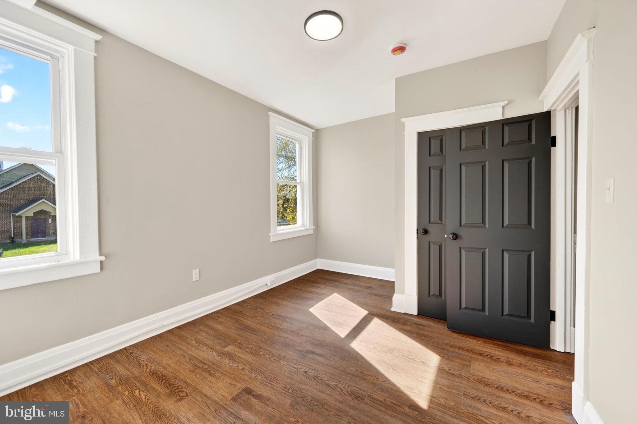 1358 Homestead Street Baltimore, MD 21218 - Photo 21 of 35 an empty room with wooden floor and windows