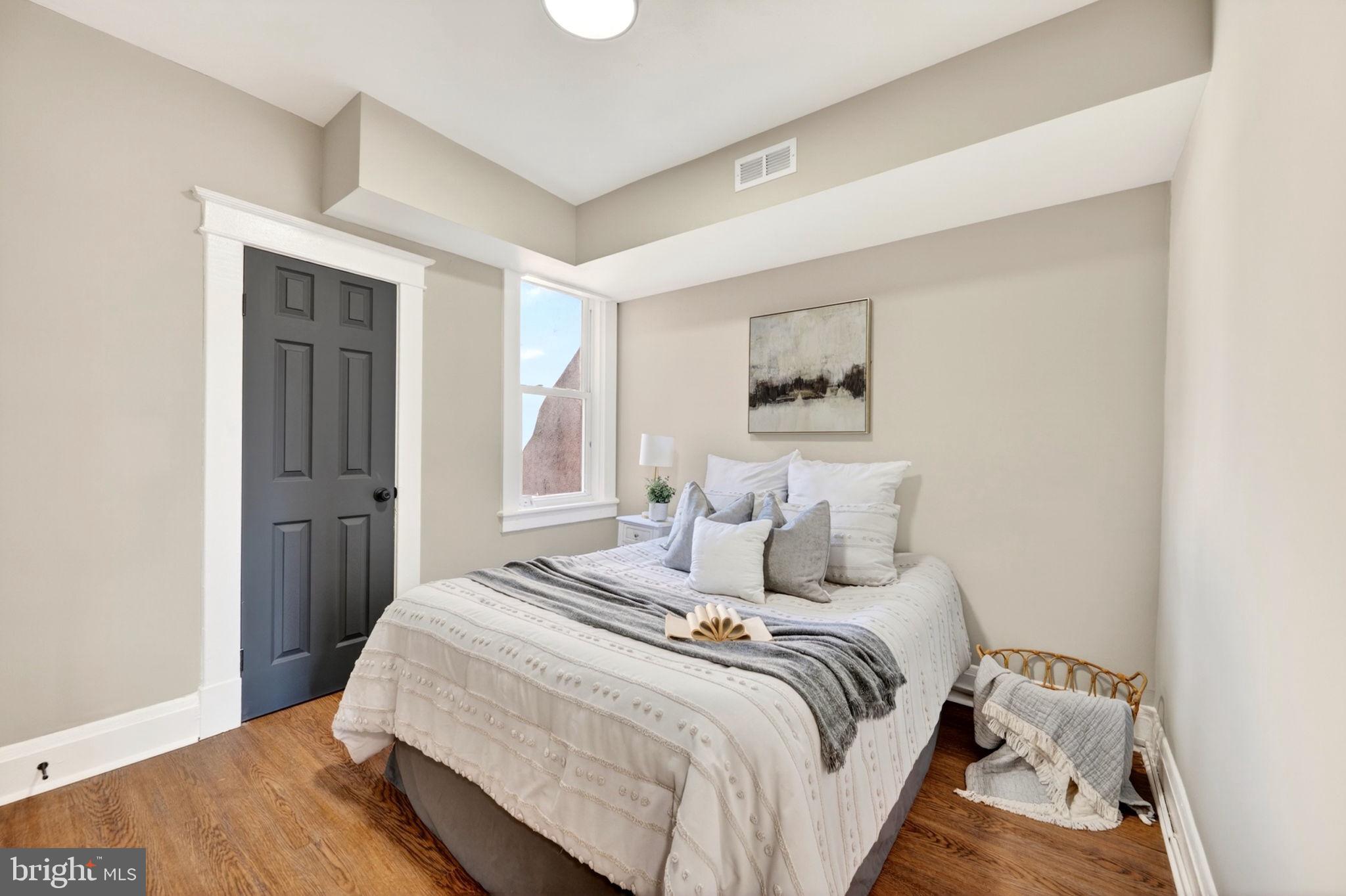 1358 Homestead Street Baltimore, MD 21218 - Photo 22 of 35 a bedroom with a large bed and a painting on the wall