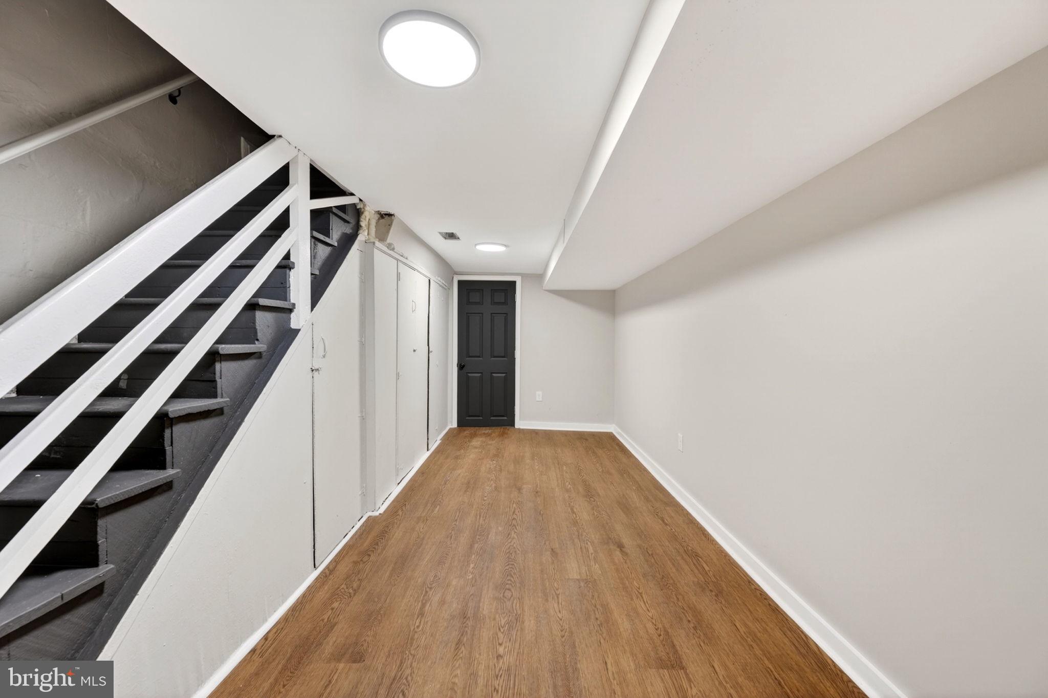 1358 Homestead Street Baltimore, MD 21218 - Photo 29 of 35 a view of a hallway with wooden floor and staircase