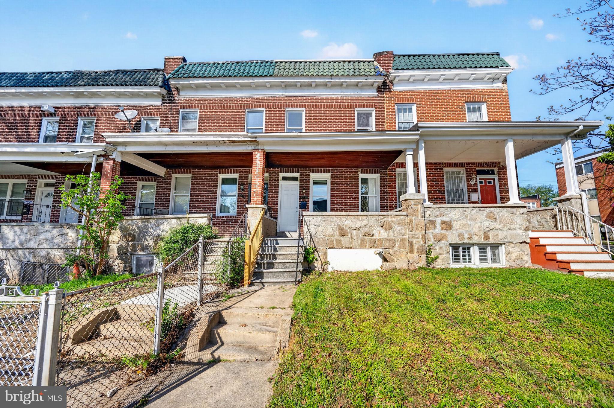 1358 Homestead Street Baltimore, MD 21218 - Photo 3 of 35 front view of a brick house with a yard