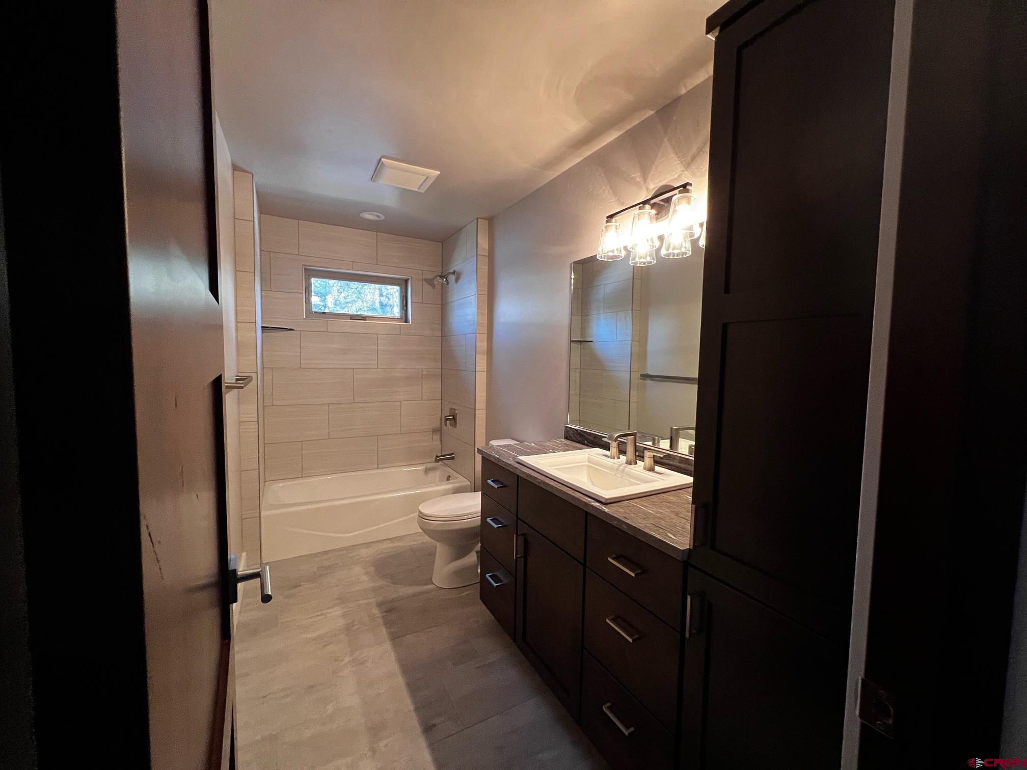 250 Edgemont Meadows Road Durango, CO 81301 - Photo 9 of 10 a bathroom with a double vanity sink toilet mirror and bathtub