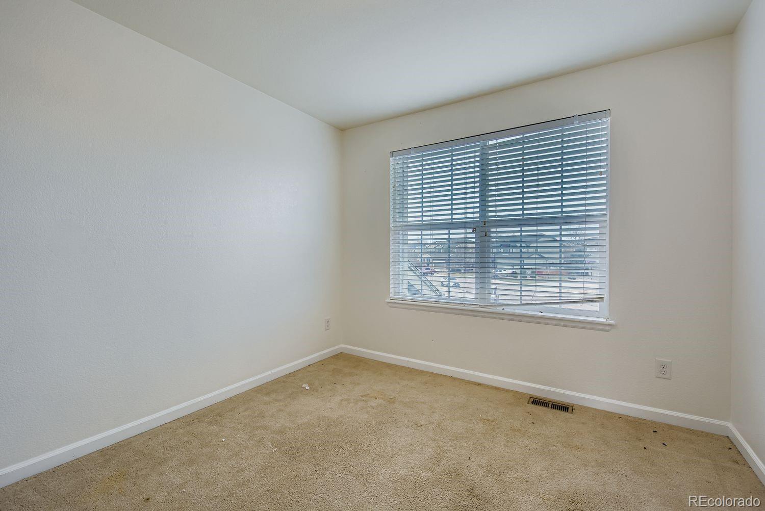 166 Bittern Drive Johnstown, CO 80534 - Photo 21 of 28 an empty room with a window