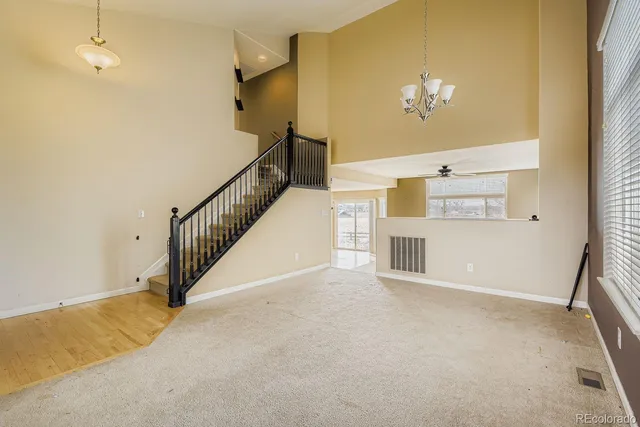 a view of livingroom with hallway and a chandelier
