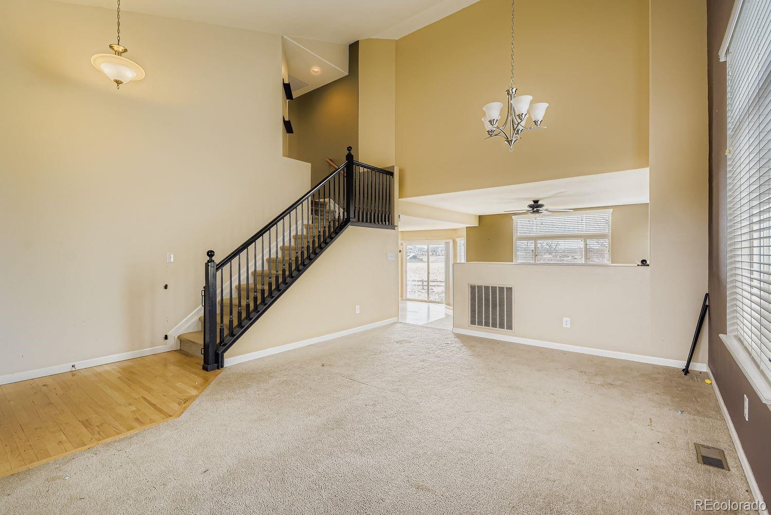 166 Bittern Drive Johnstown, CO 80534 - Photo 5 of 28 a view of livingroom with hallway and a chandelier