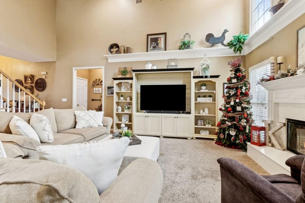 4385 Signal Ridge Court Buford, GA 30518 - Photo 12 of 81 a living room with furniture a flat screen tv and a fireplace