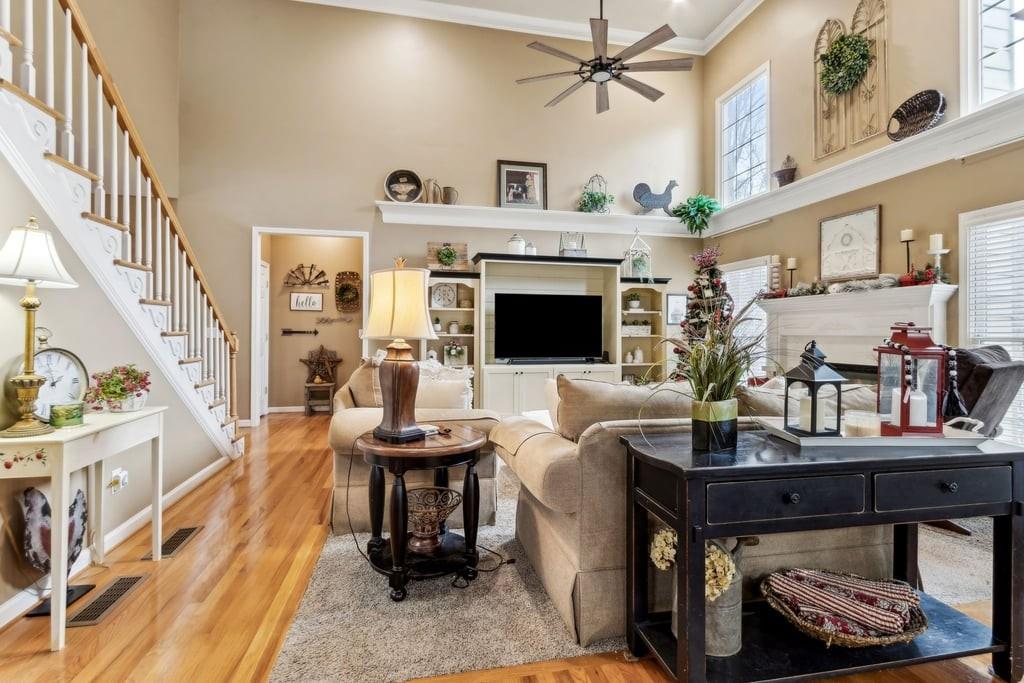 4385 Signal Ridge Court Buford, GA 30518 - Photo 14 of 81 a living room with furniture a fireplace and a table