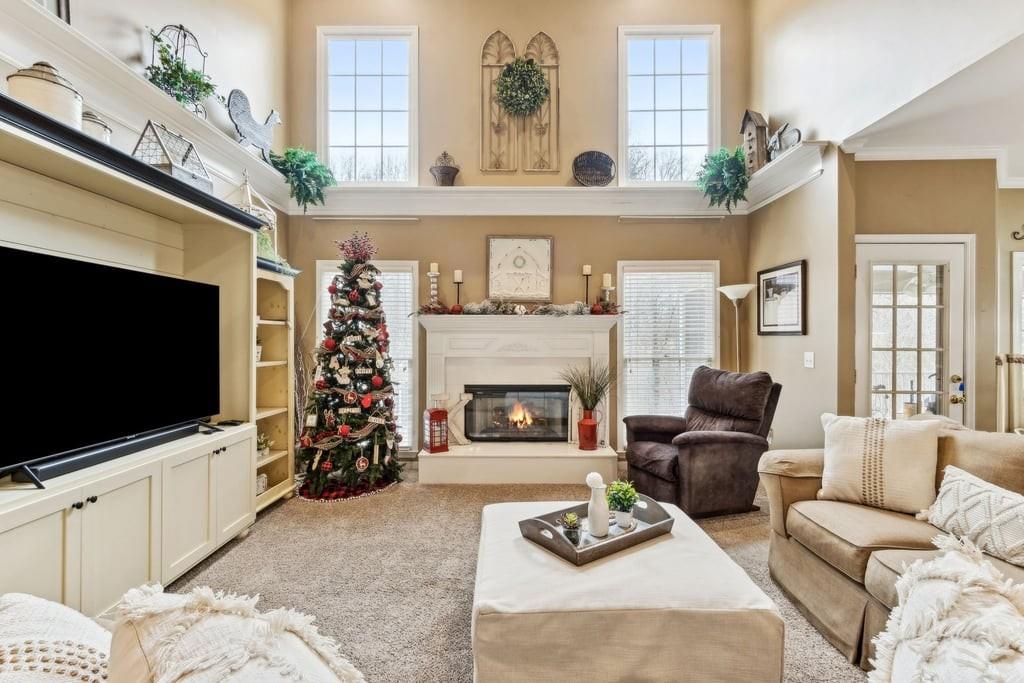 4385 Signal Ridge Court Buford, GA 30518 - Photo 15 of 81 a living room with furniture a flat screen tv and a fireplace