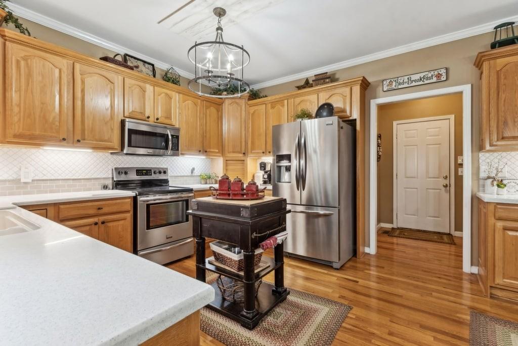 4385 Signal Ridge Court Buford, GA 30518 - Photo 20 of 81 a kitchen with stainless steel appliances granite countertop a refrigerator a stove a sink a oven with a dining table and chairs