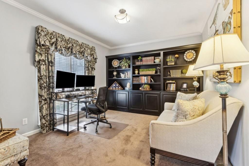 4385 Signal Ridge Court Buford, GA 30518 - Photo 25 of 81 a living room with furniture a flat screen tv and a floor to ceiling window