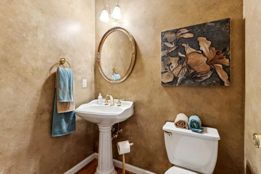 4385 Signal Ridge Court Buford, GA 30518 - Photo 28 of 81 a bathroom with a toilet sink and mirror