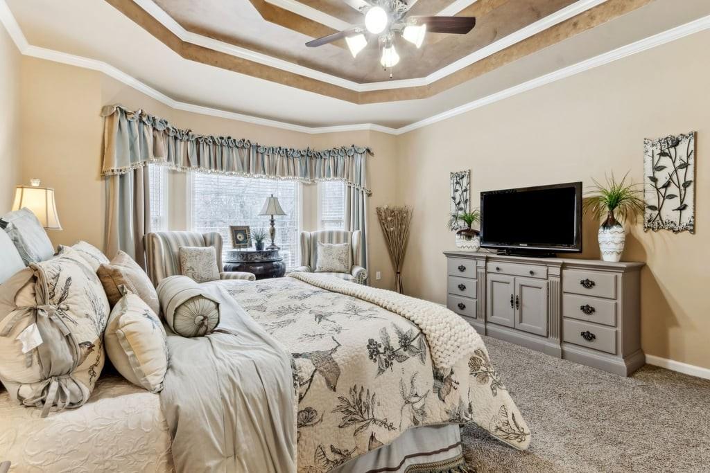 4385 Signal Ridge Court Buford, GA 30518 - Photo 30 of 81 a bedroom with a bed and a flat screen tv