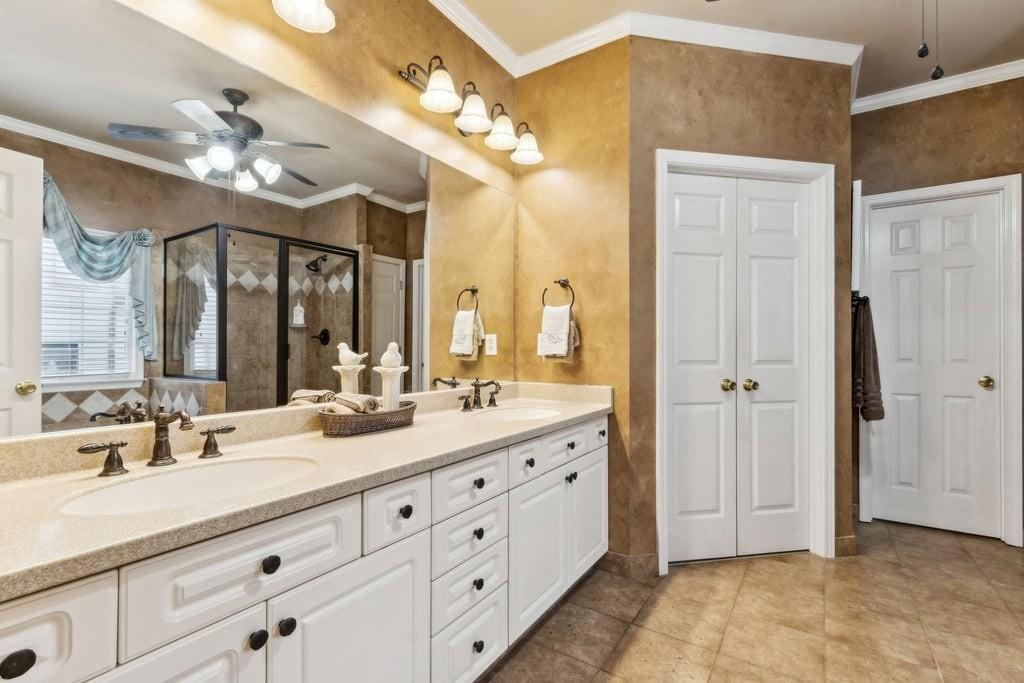 4385 Signal Ridge Court Buford, GA 30518 - Photo 32 of 81 a bathroom with a double vanity sink mirror and chandelier
