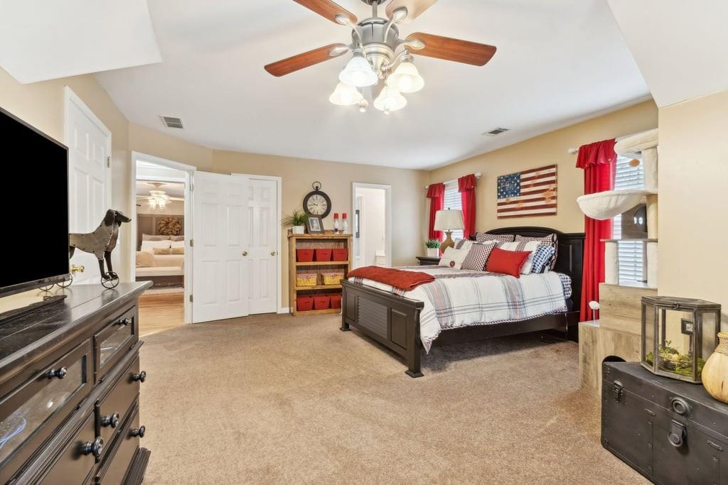 4385 Signal Ridge Court Buford, GA 30518 - Photo 43 of 81 a bedroom with a bed and a flat screen tv