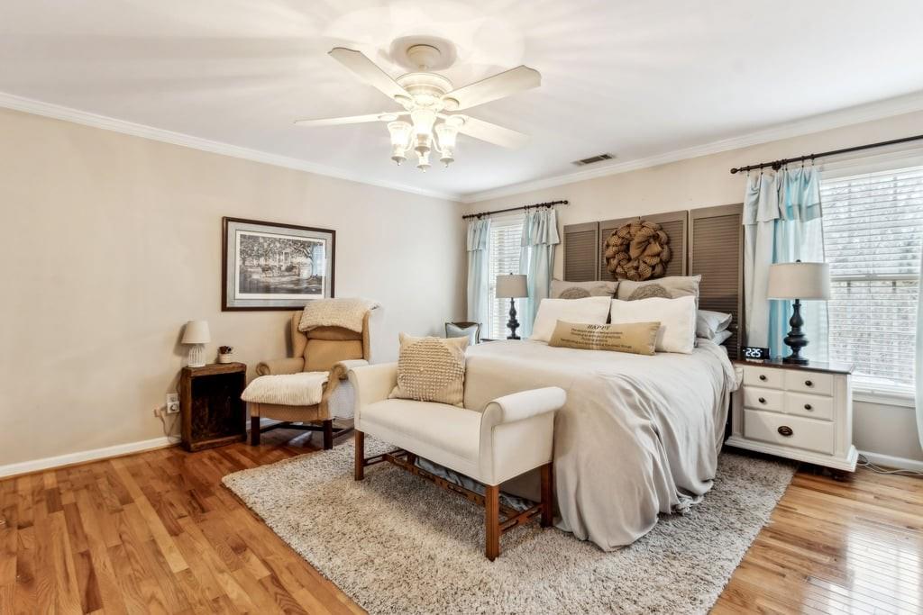 4385 Signal Ridge Court Buford, GA 30518 - Photo 49 of 81 a bedroom with a bed and a chandelier