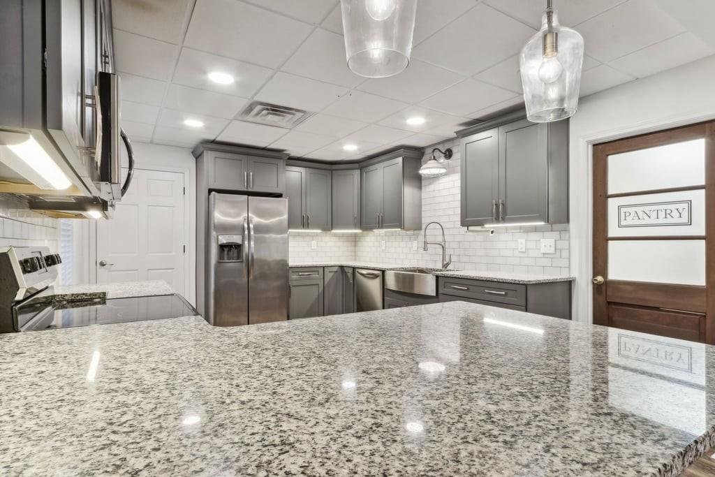 4385 Signal Ridge Court Buford, GA 30518 - Photo 53 of 81 a large kitchen with kitchen island a large counter top stainless steel appliances and cabinets