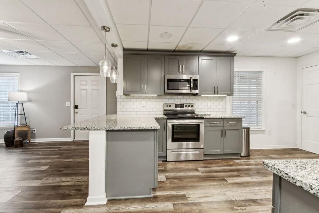 4385 Signal Ridge Court Buford, GA 30518 - Photo 57 of 81 a kitchen with stainless steel appliances granite countertop a sink a stove and a refrigerator