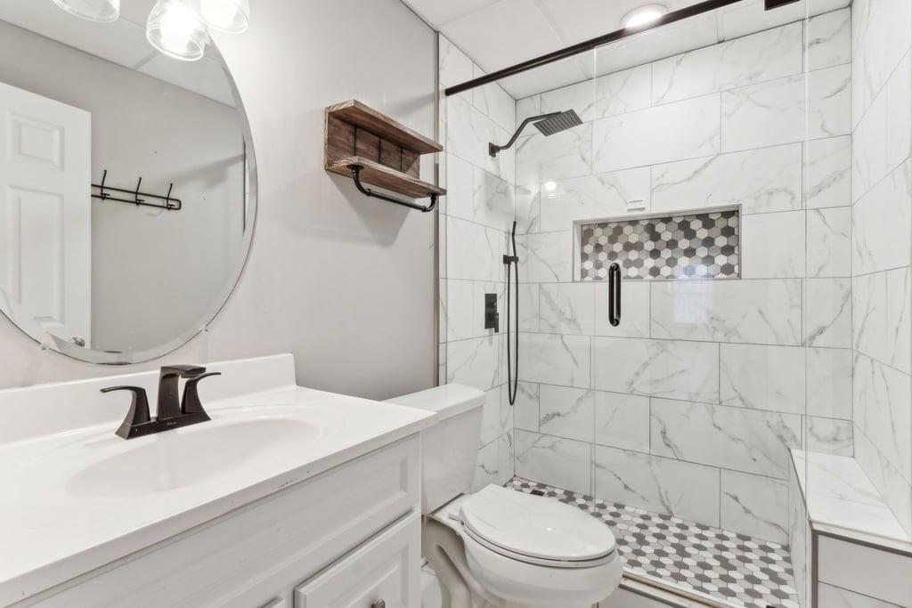 4385 Signal Ridge Court Buford, GA 30518 - Photo 62 of 81 a bathroom with a sink toilet a mirror and shower