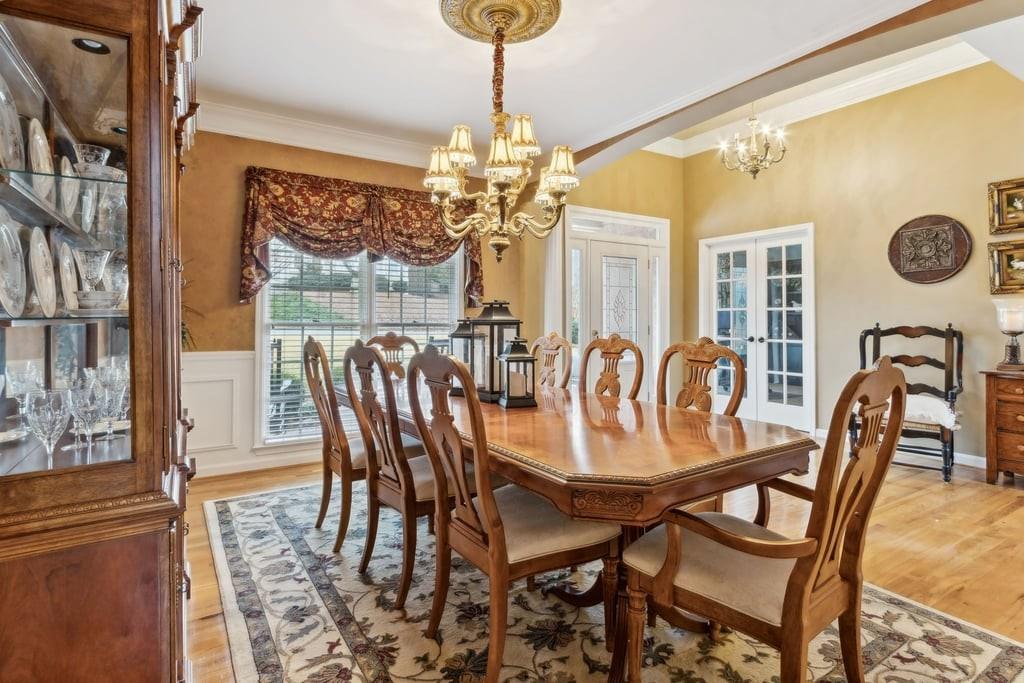 4385 Signal Ridge Court Buford, GA 30518 - Photo 9 of 81 a dining room with furniture a chandelier and window