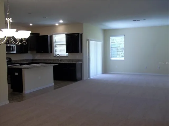 a kitchen with stainless steel appliances granite countertop a sink and a stove