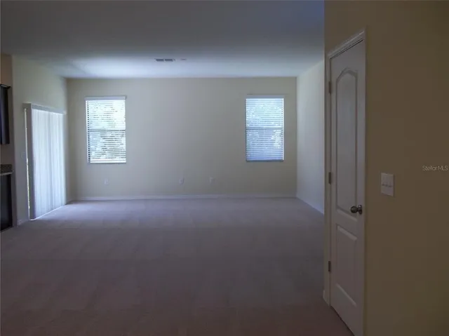 a view of empty room with windows