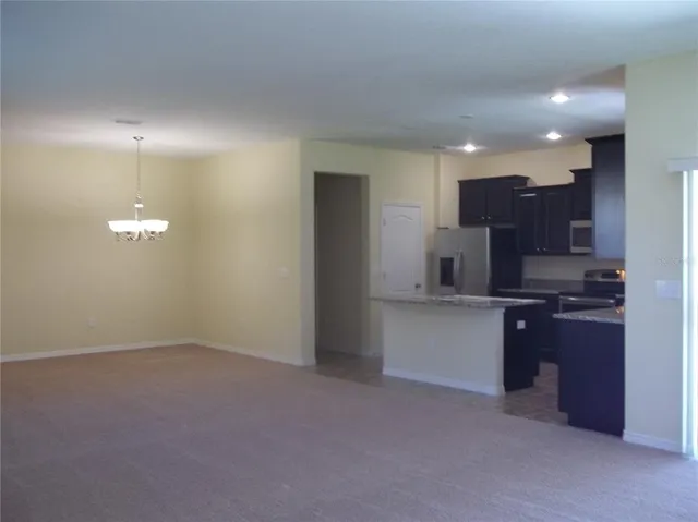 a kitchen with kitchen island granite countertop stainless steel appliances lots of counter top space