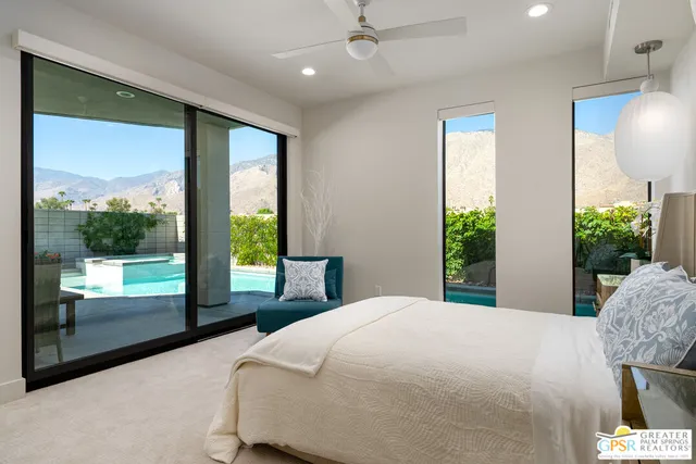 a bedroom with a large bed and a large window