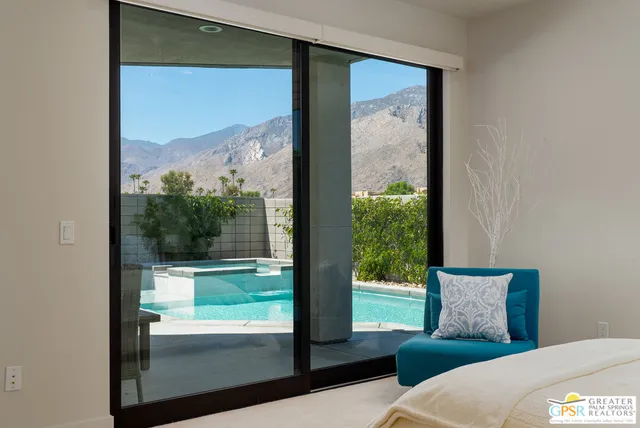 a view of a room with a large window and front of door