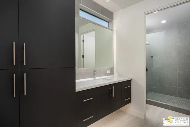 a bathroom with a double vanity sink and mirror