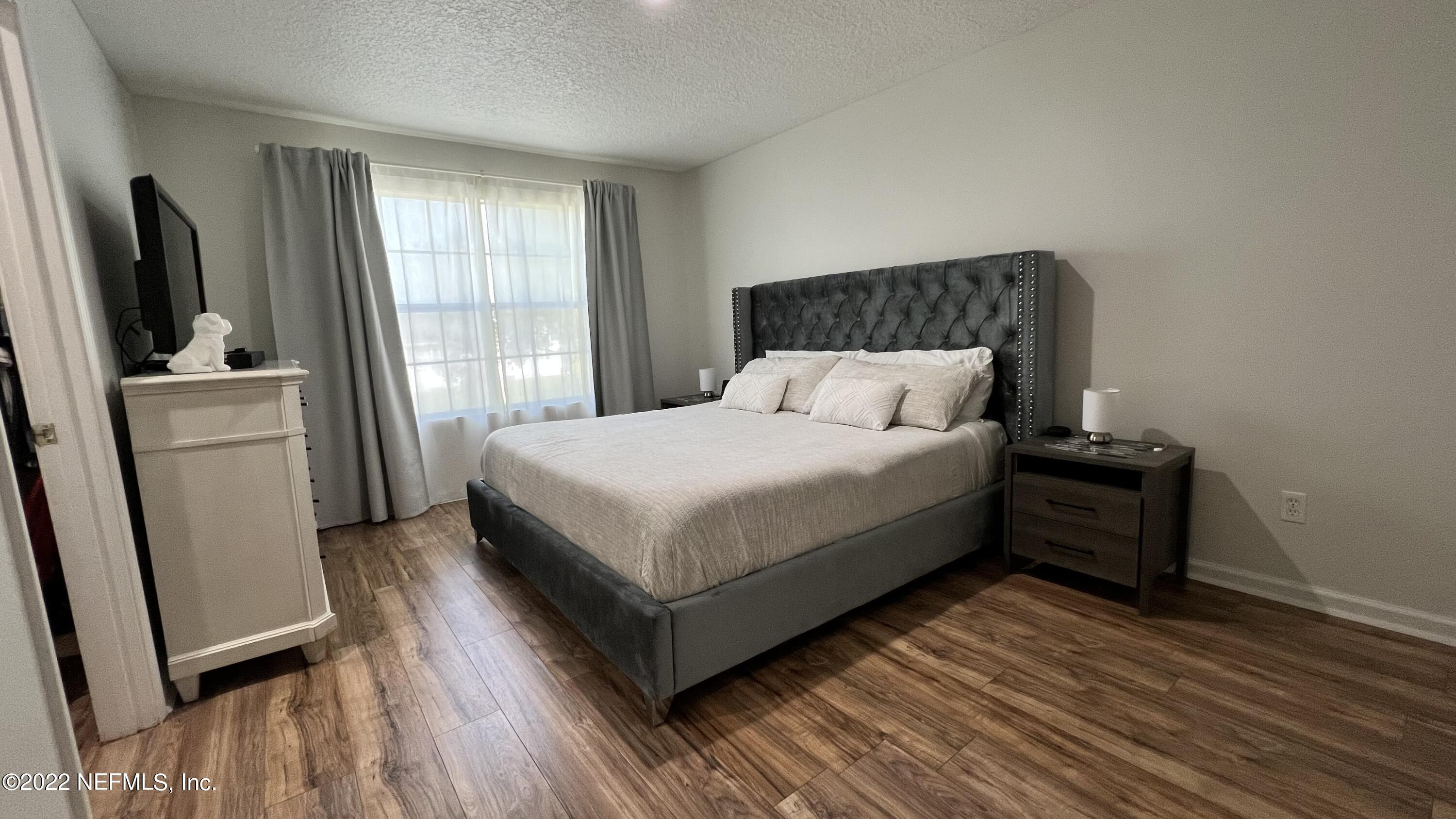 1684 Mayfair Road Jacksonville, FL 32207 - Photo 13 of 34 a large bed sitting in a bedroom next to a window