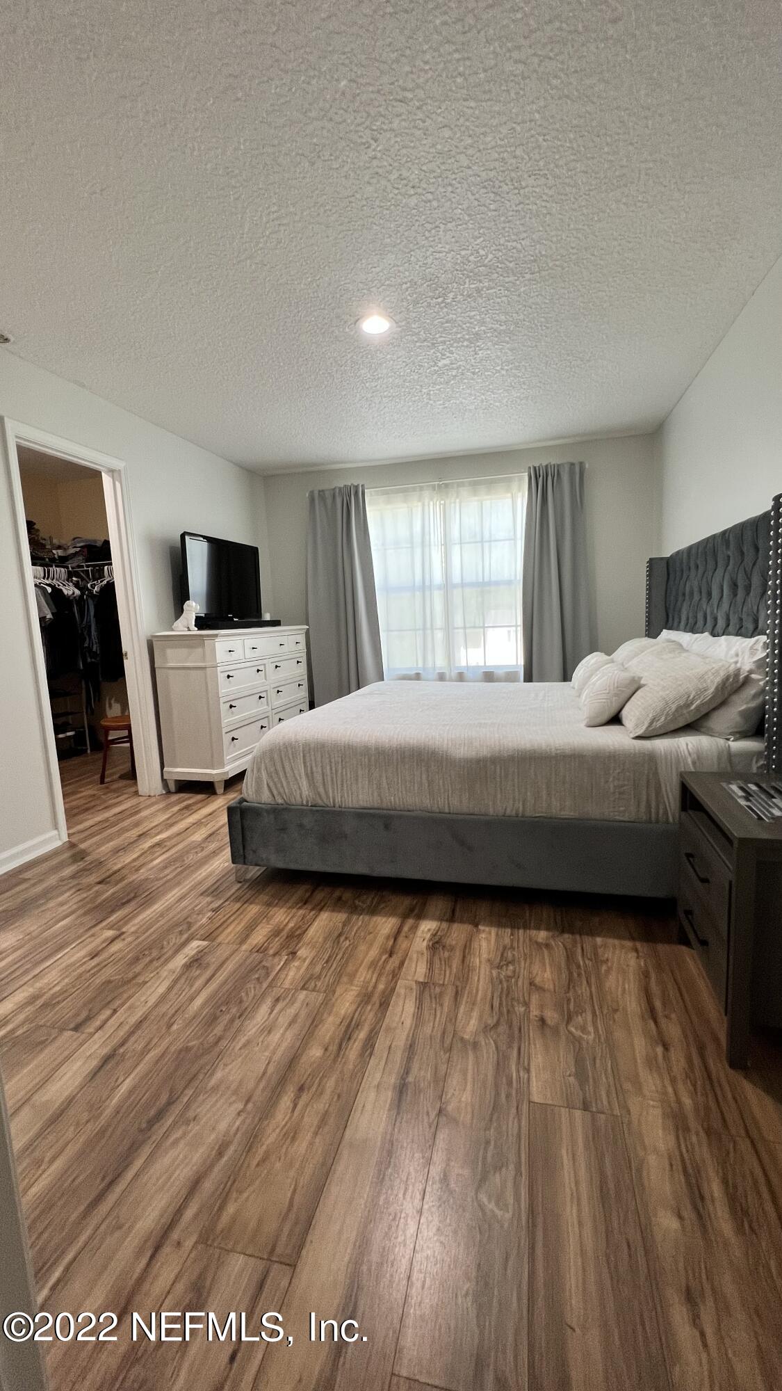 1684 Mayfair Road Jacksonville, FL 32207 - Photo 14 of 34 a bedroom with a large bed and a window
