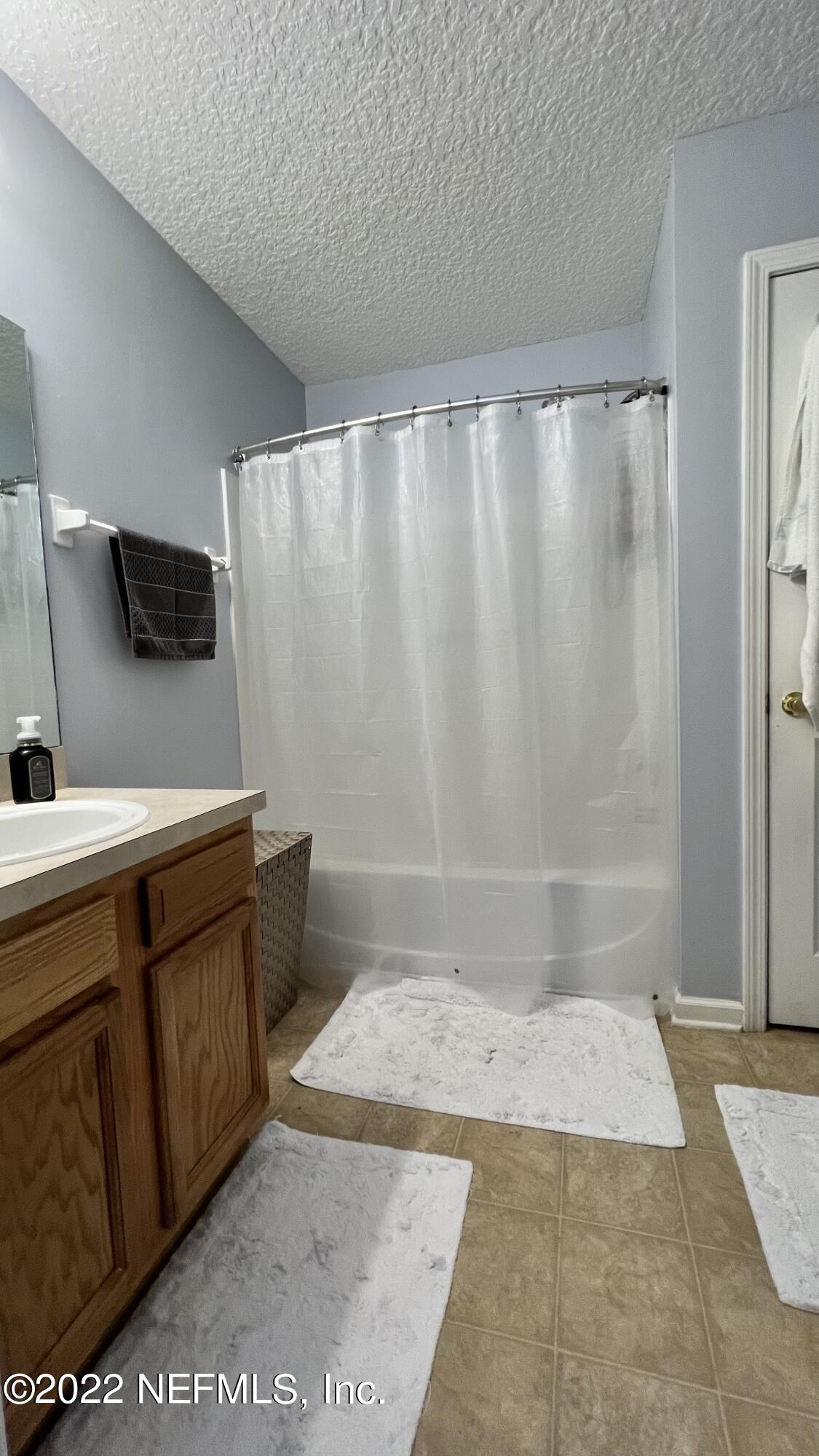 1684 Mayfair Road Jacksonville, FL 32207 - Photo 15 of 34 a bathroom with a granite countertop sink and a mirror