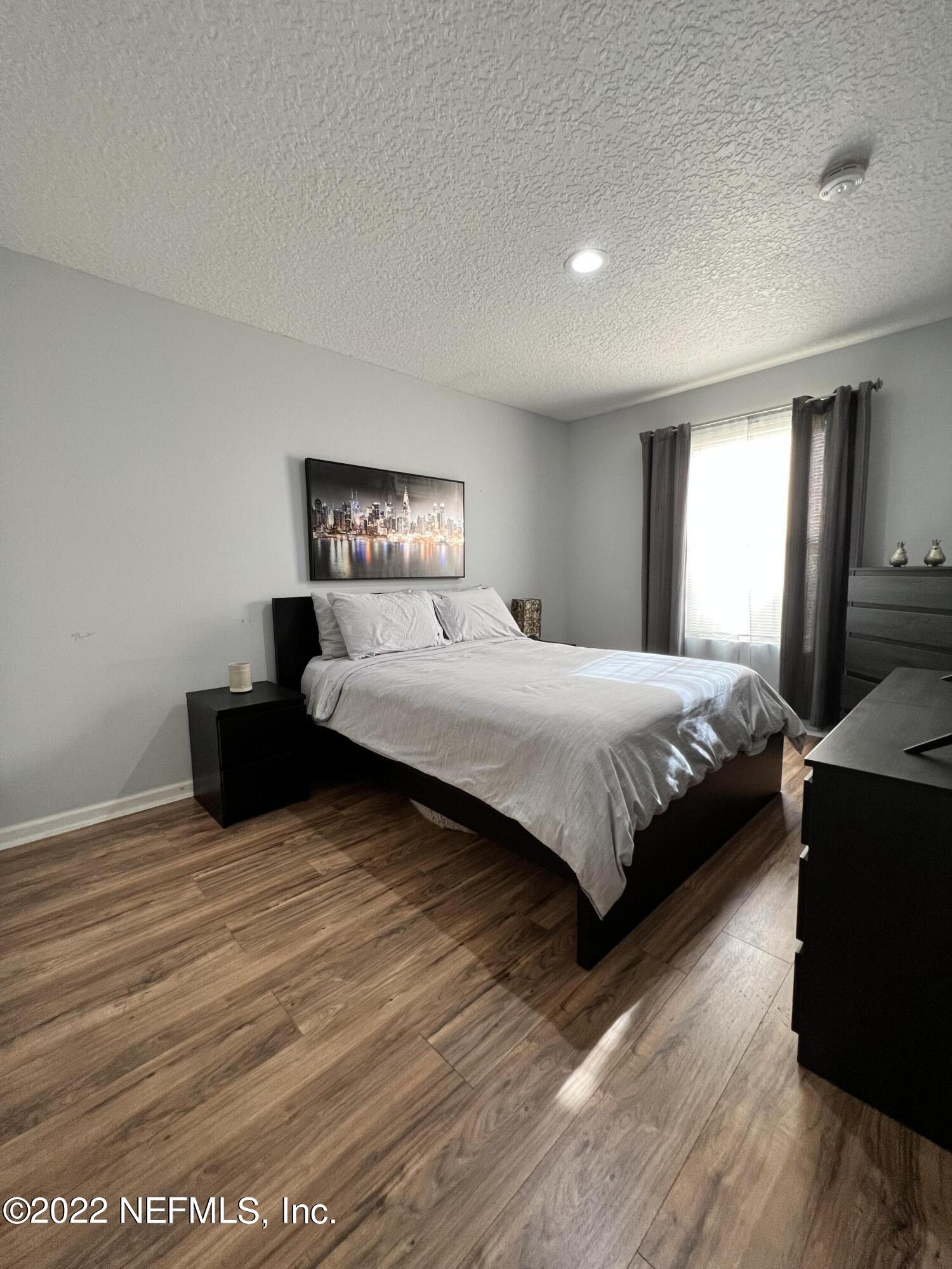 1684 Mayfair Road Jacksonville, FL 32207 - Photo 20 of 34 a bedroom with a bed and wooden floor