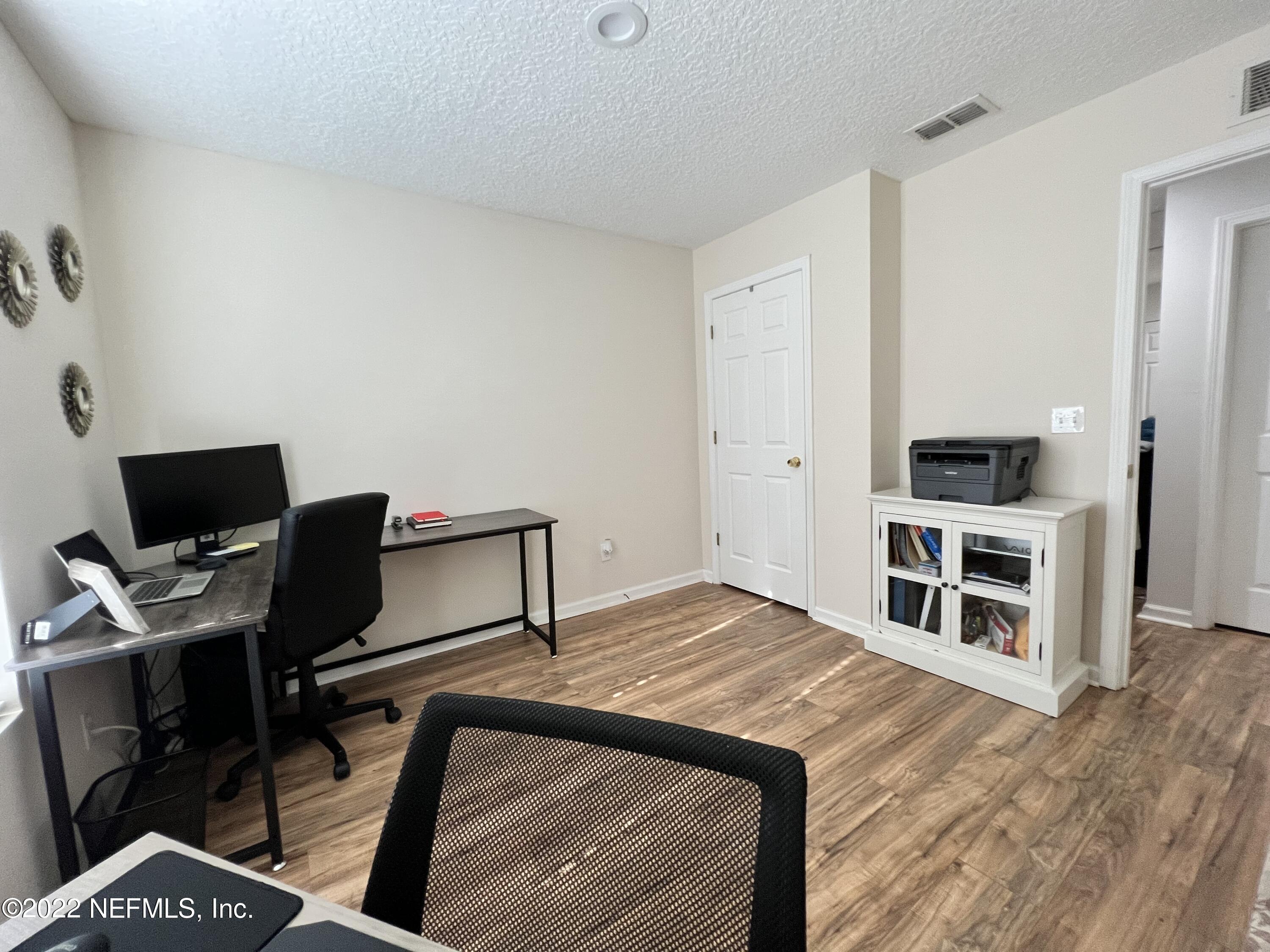 1684 Mayfair Road Jacksonville, FL 32207 - Photo 23 of 34 a bedroom with a bed and a flat screen tv