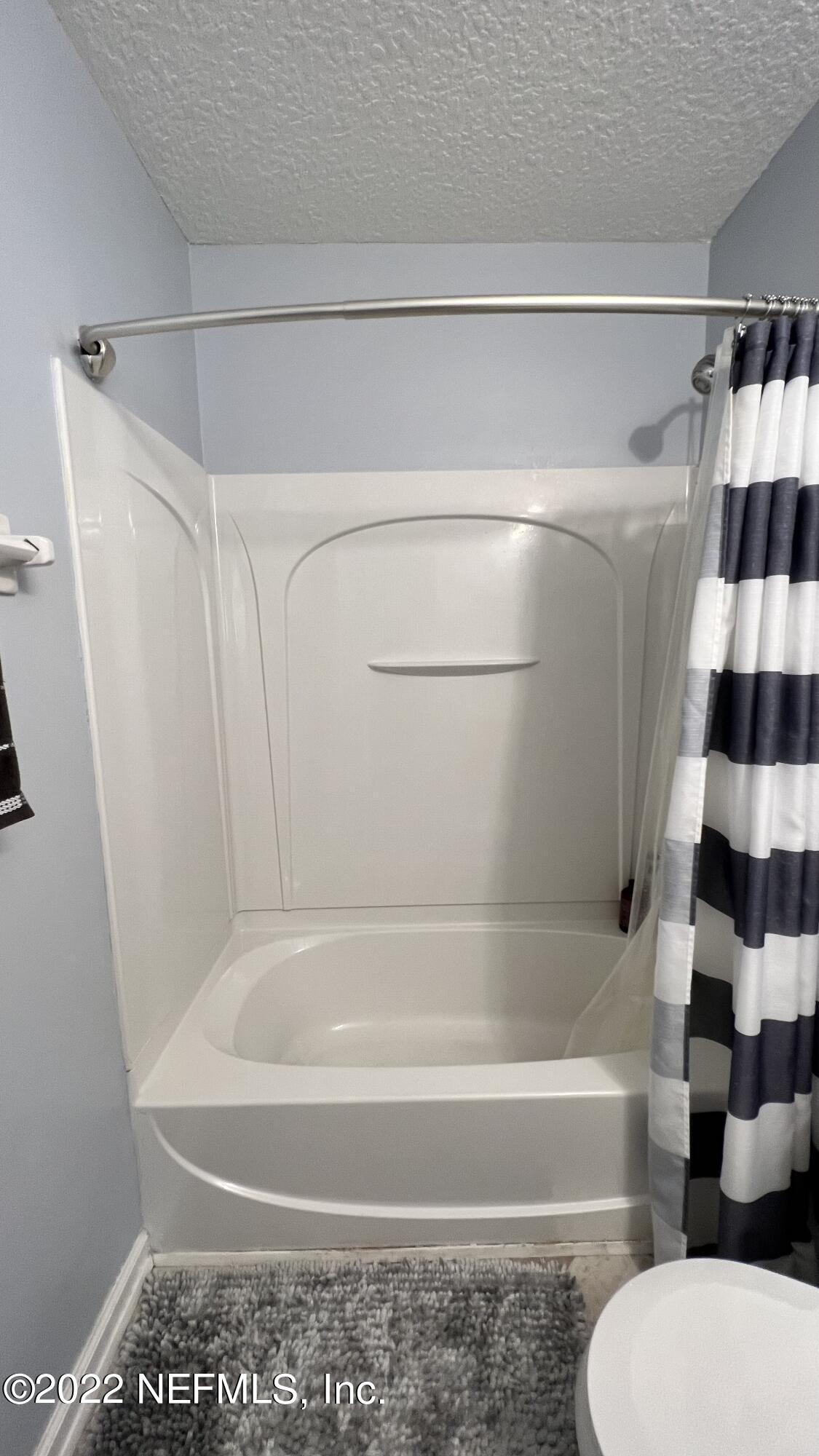 1684 Mayfair Road Jacksonville, FL 32207 - Photo 24 of 34 a bathroom with a bathtub and a shower