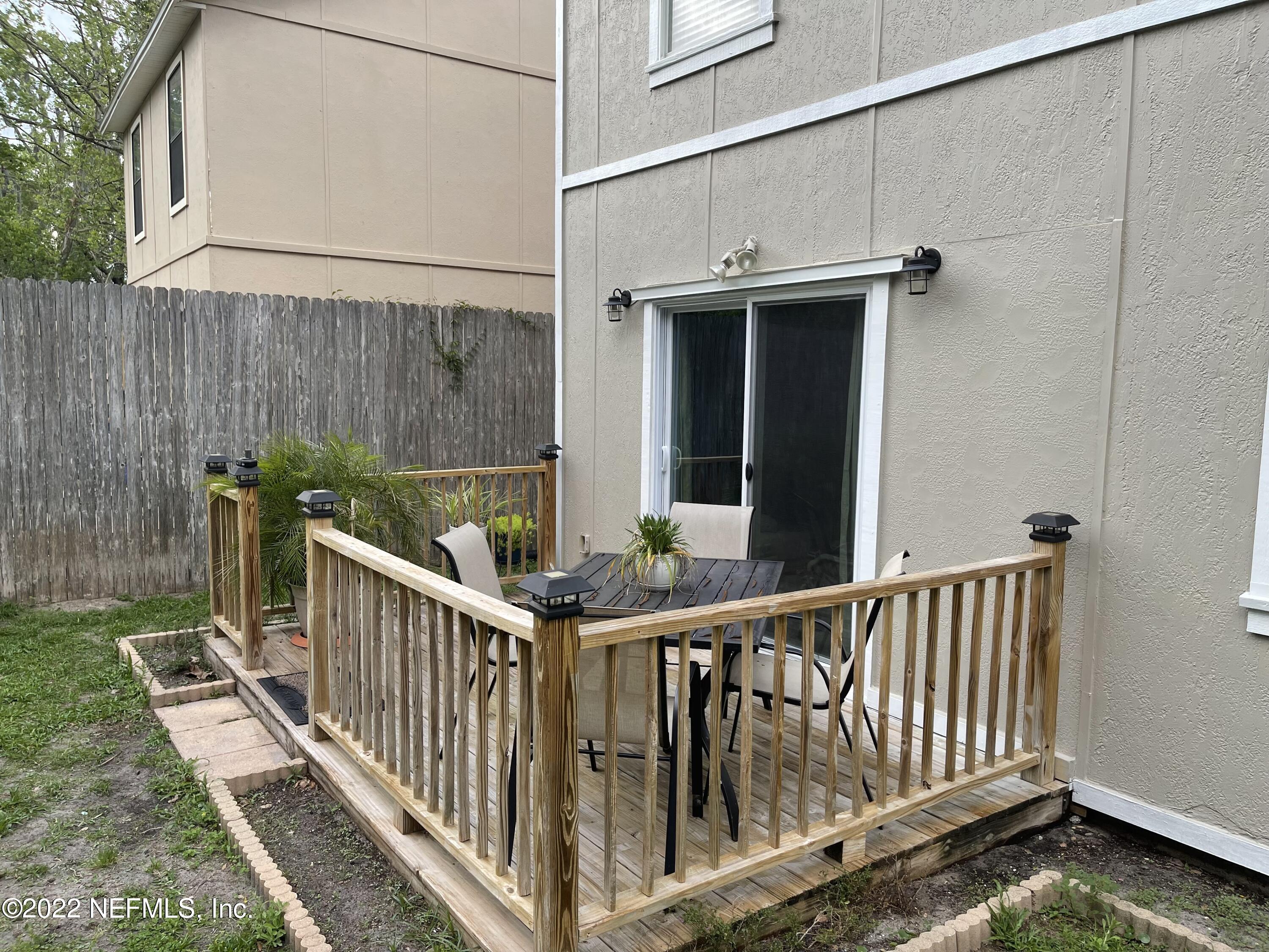 1684 Mayfair Road Jacksonville, FL 32207 - Photo 27 of 34 a view of a small yard and wooden fence