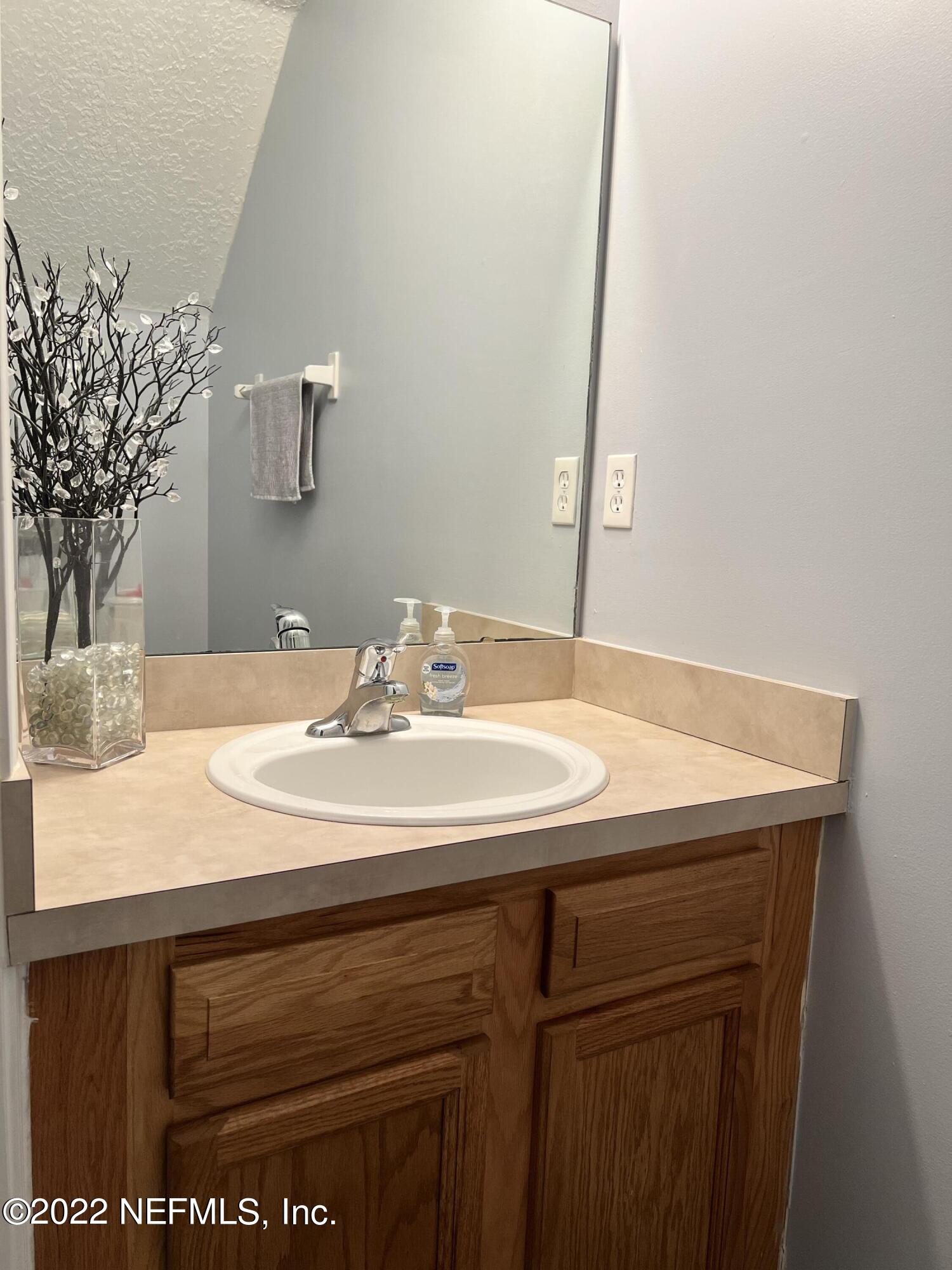 1684 Mayfair Road Jacksonville, FL 32207 - Photo 10 of 34 a bathroom with a sink and a mirror