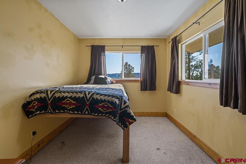85 Hideaway Road Durango, CO 81303 - Photo 23 of 33 a bedroom with a bed and a window