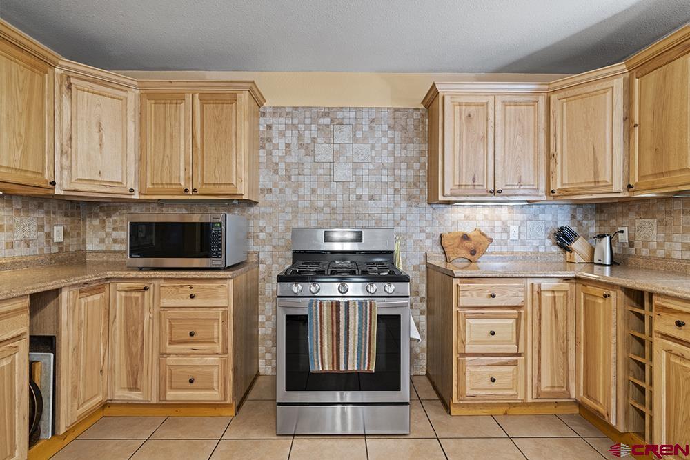 85 Hideaway Road Durango, CO 81303 - Photo 6 of 33 a kitchen with granite countertop white cabinets and stainless steel appliances