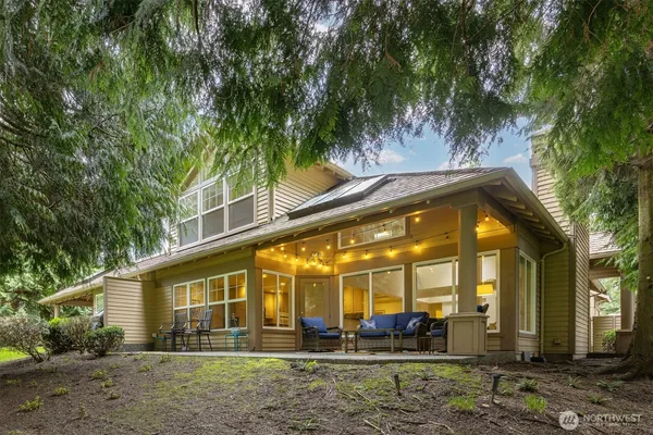a view of a large building with potted plants and large trees