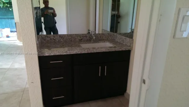 a kitchen with a refrigerator and cabinets