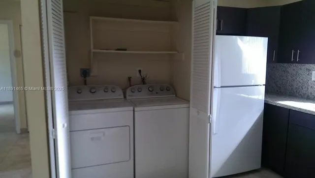 a kitchen with a sink and a refrigerator