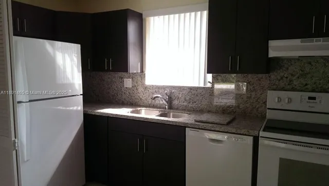 a kitchen with a stove and a refrigerator