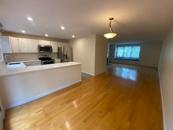 a kitchen with stainless steel appliances a refrigerator sink and microwave