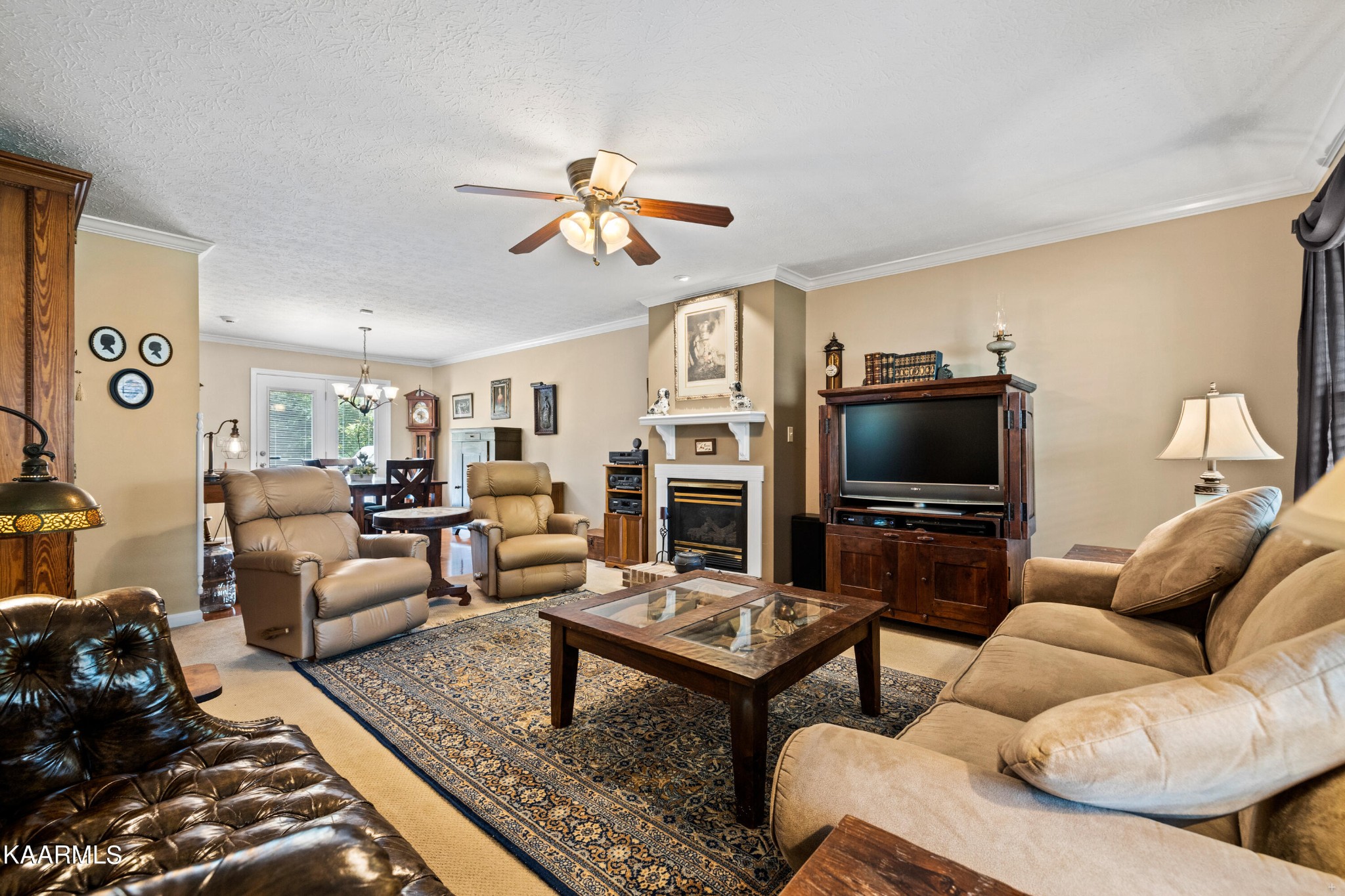 114 Capital Circle Oak Ridge, TN 37830 - Photo 8 of 50 a living room with furniture a flat screen tv and kitchen view