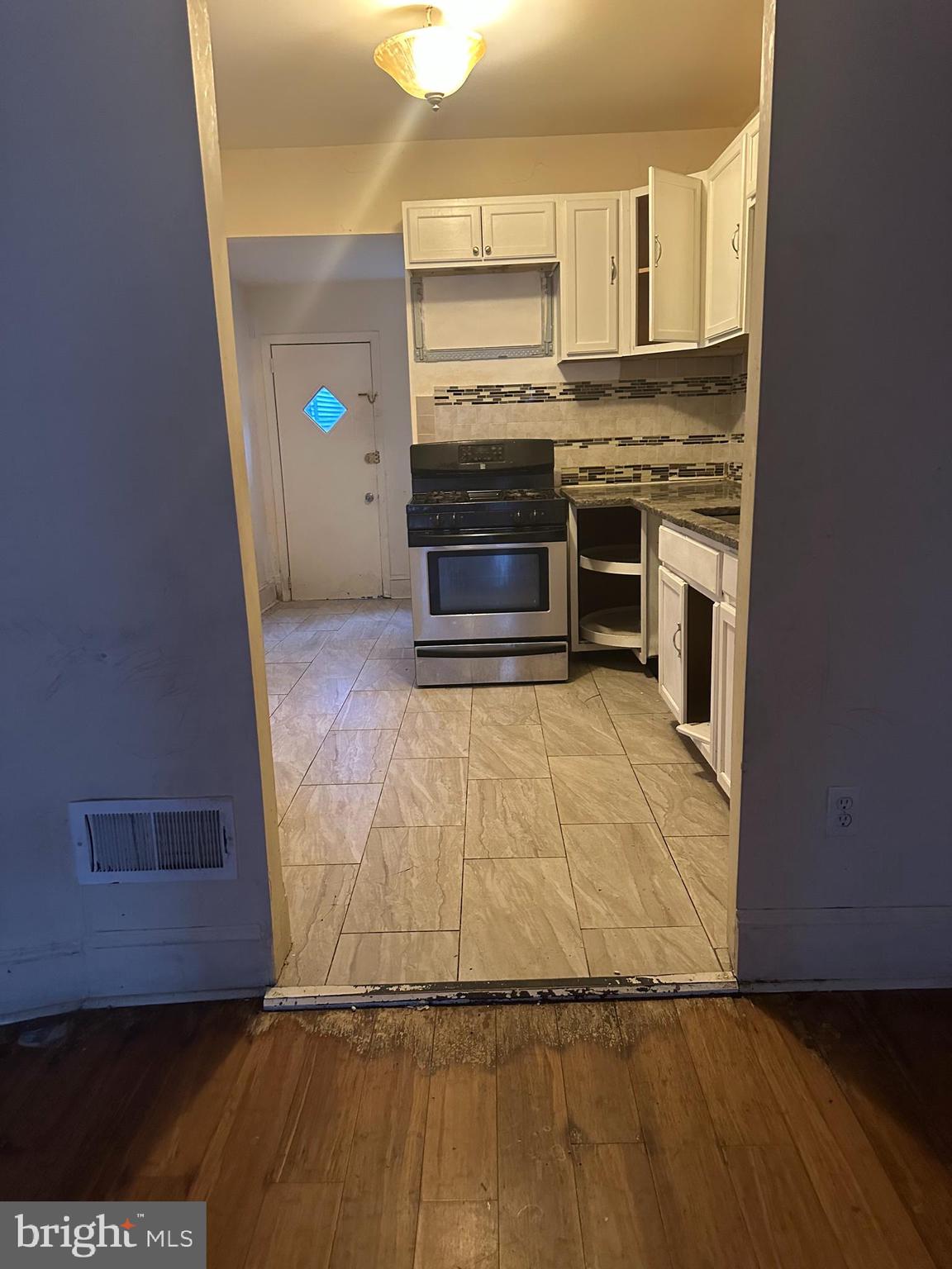 1656 Granite Street Philadelphia, PA 19124 - Photo 3 of 10 a kitchen with granite countertop a stove and a refrigerator