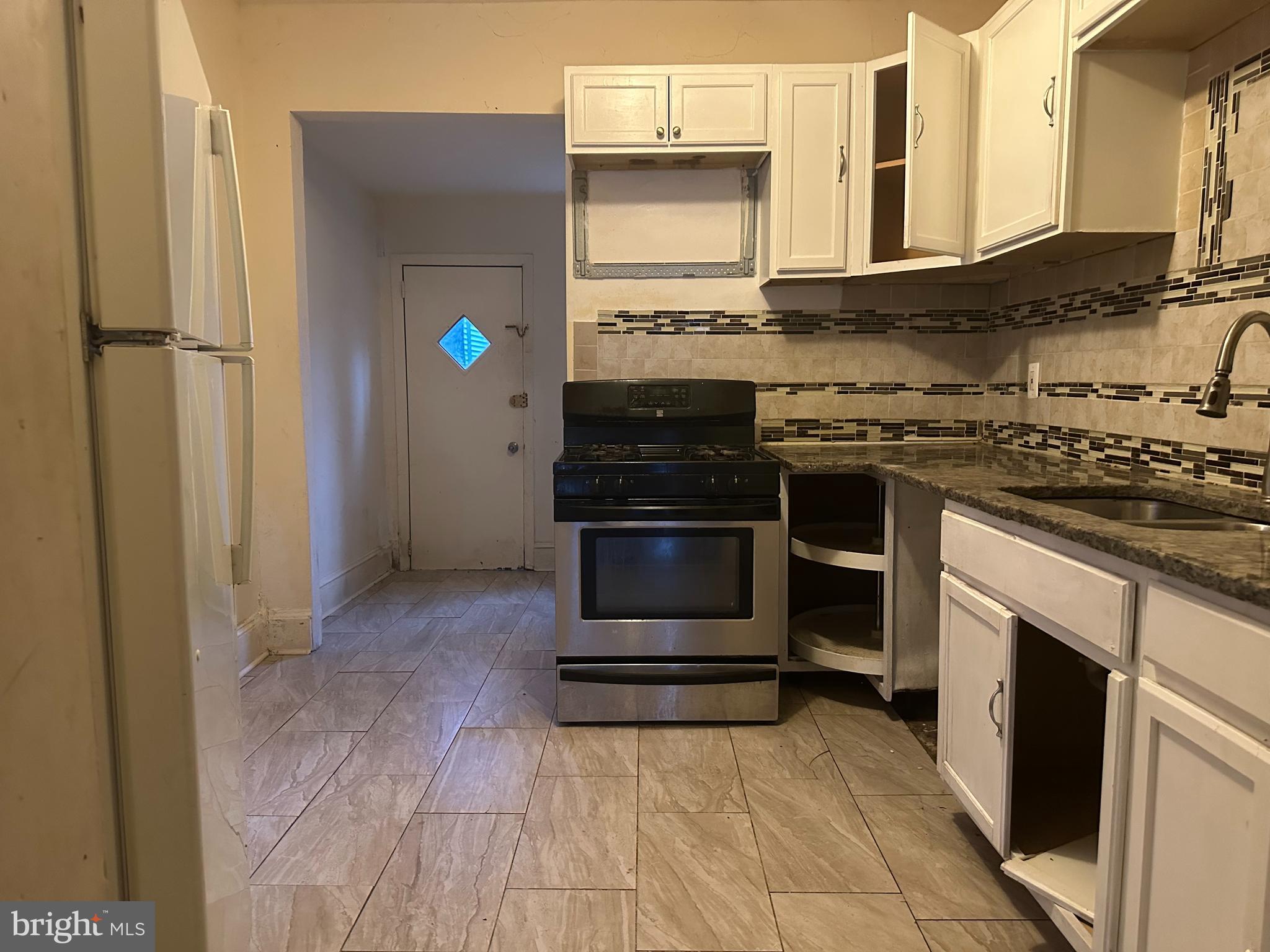 1656 Granite Street Philadelphia, PA 19124 - Photo 4 of 10 a kitchen with stainless steel appliances granite countertop a stove and a refrigerator