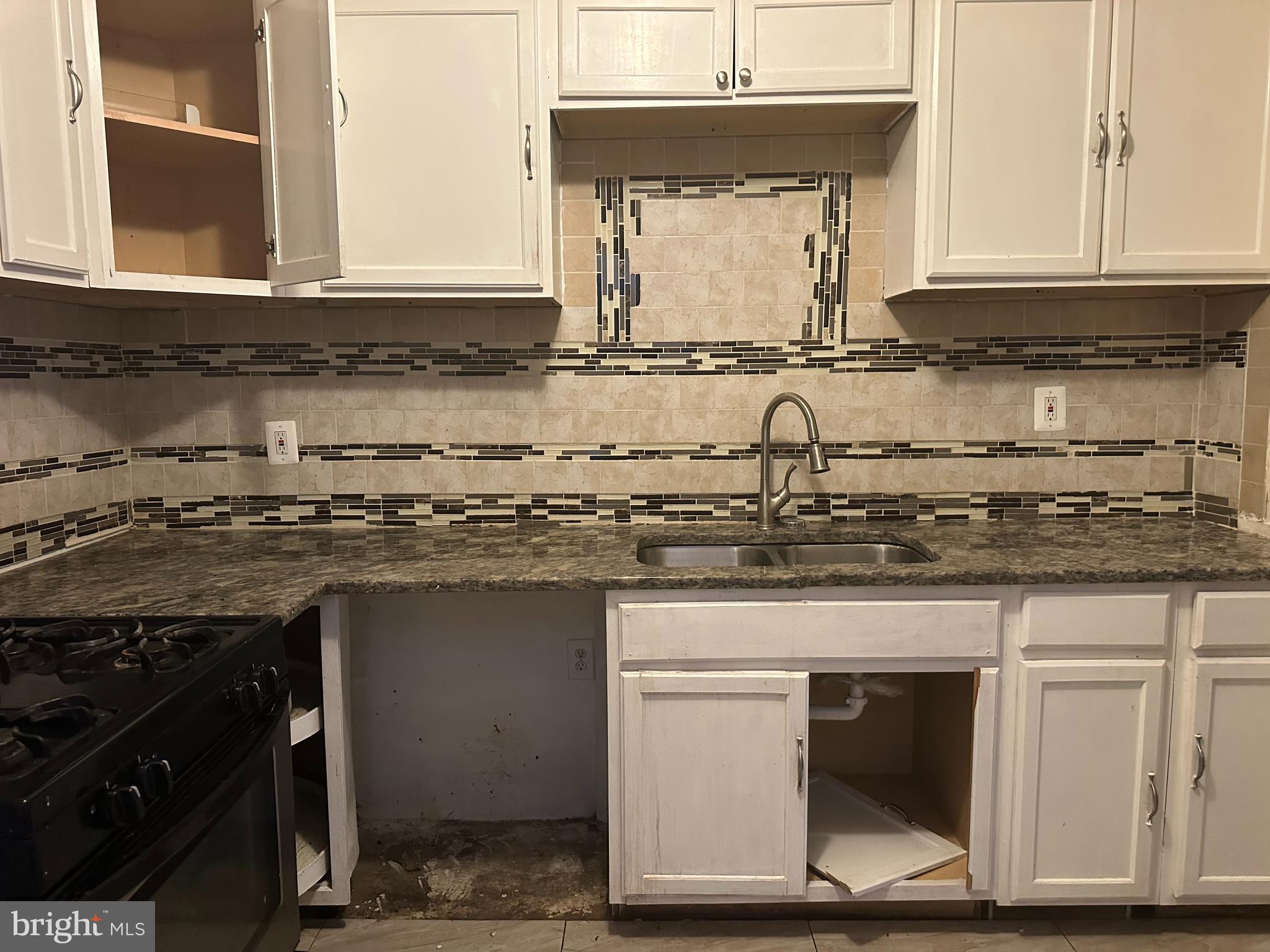1656 Granite Street Philadelphia, PA 19124 - Photo 5 of 10 a kitchen with stainless steel appliances granite countertop a stove a sink and a microwave