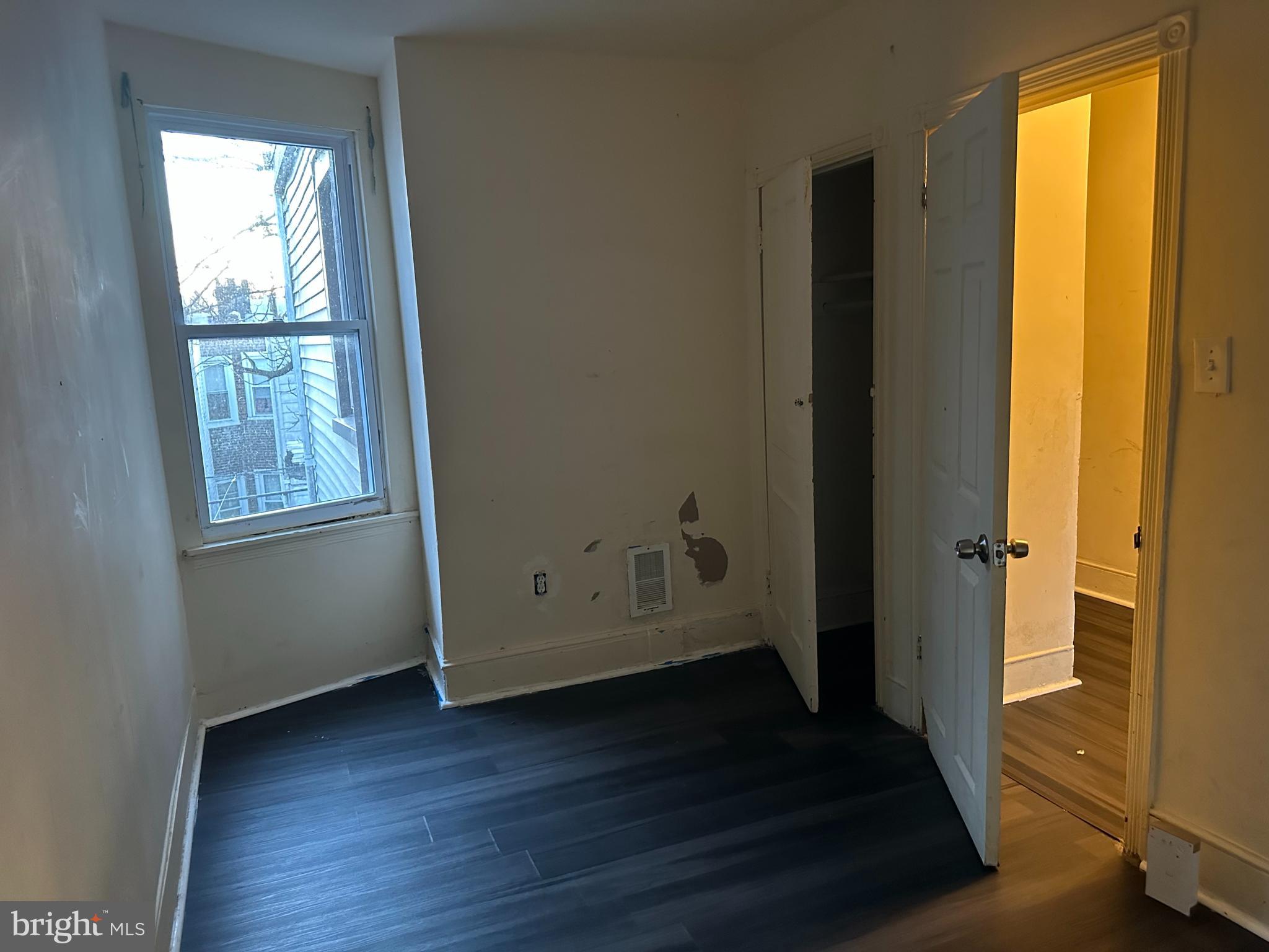 1656 Granite Street Philadelphia, PA 19124 - Photo 8 of 10 a view of an empty room with wooden floor and a window